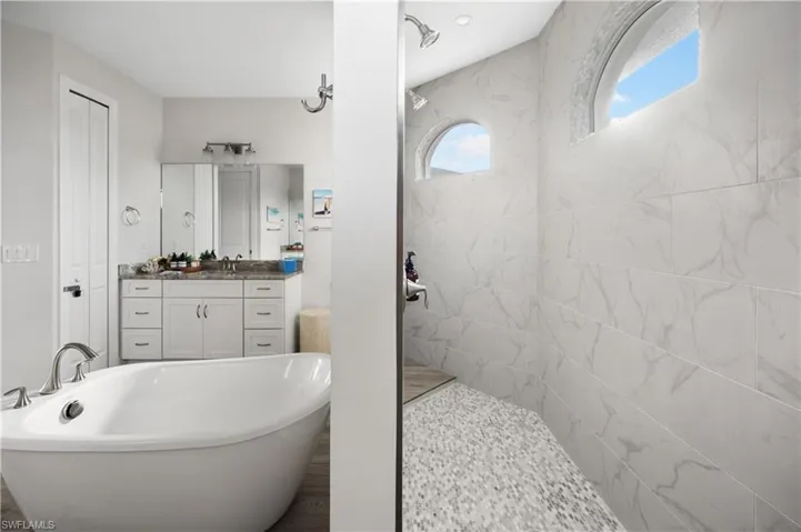 Bathroom featuring vanity and a tub