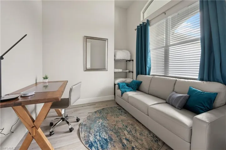 Home office with light hardwood / wood-style flooring and a wealth of natural light