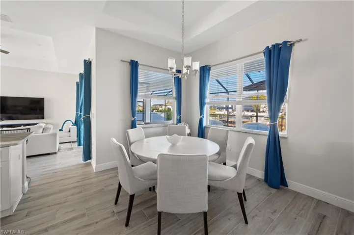 Dining room featuring a notable chandelier and a tray ceiling