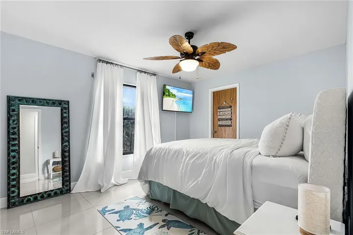 Tiled bedroom with ceiling fan