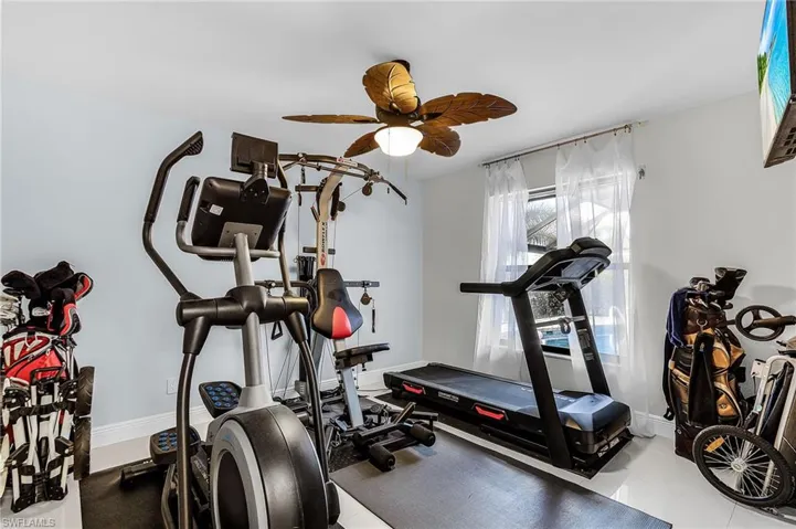 Workout area with baseboards and a ceiling fan