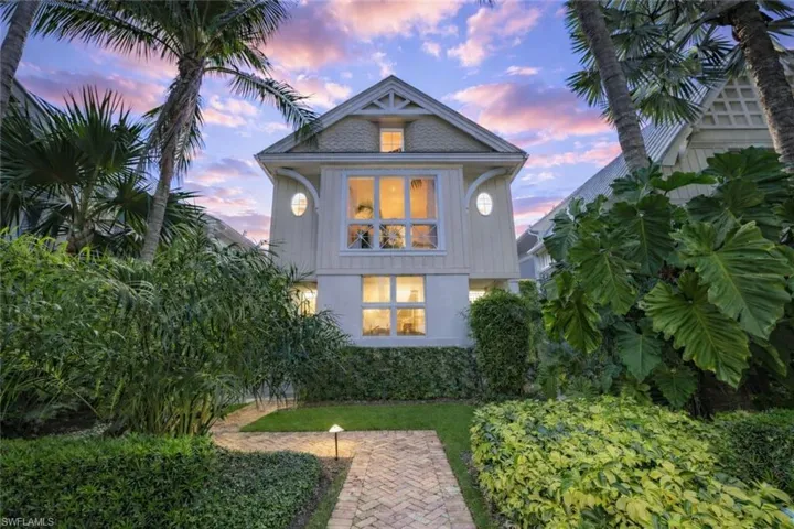 Back of property at dusk with stucco siding