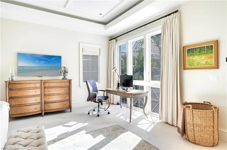 Office area with light colored carpet and baseboards