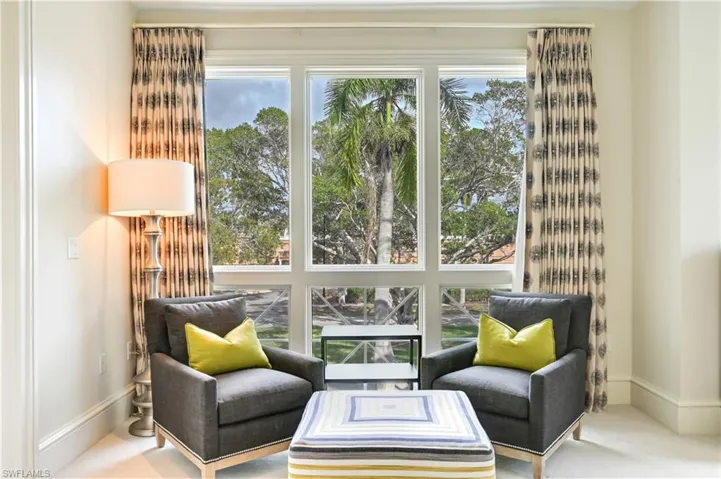 Living area featuring carpet and baseboards