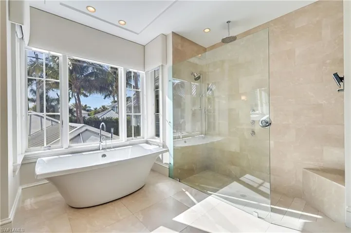 Full bath featuring a soaking tub, a walk in shower, tile patterned floors, and recessed lighting