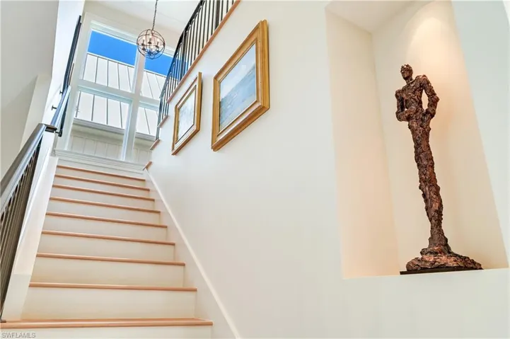 Stairway with a high ceiling and suspended lighting