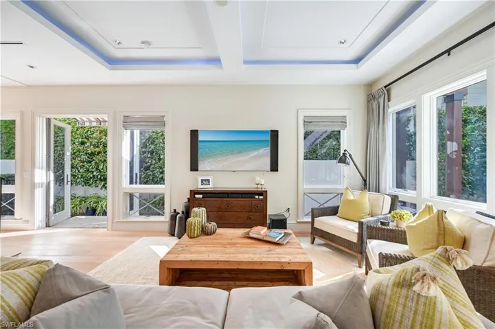 Living room with wood finished floors and a raised ceiling
