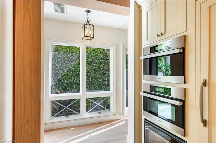 Kitchen featuring hanging lights and stainless steel appliances