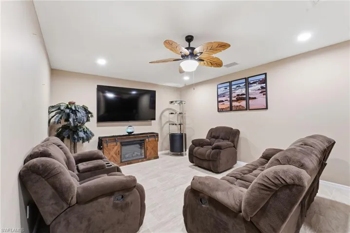 Living room with recessed lighting and a ceiling fan