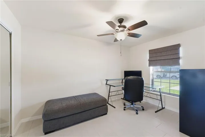 Office area featuring baseboards and a ceiling fan