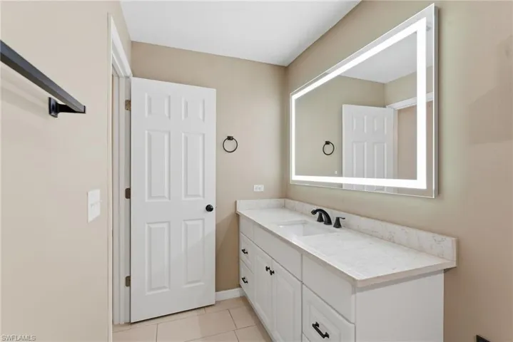 Bathroom featuring vanity and light tile patterned flooring