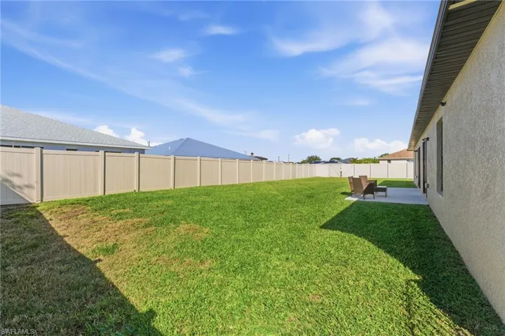 Fenced backyard with a patio
