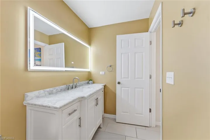 Bathroom with vanity and light tile patterned floors