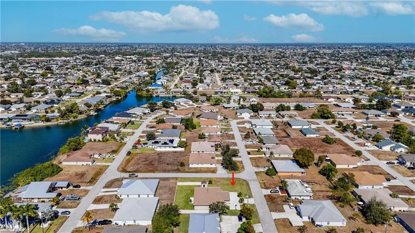 Aerial view of property's location with nearby suburban area