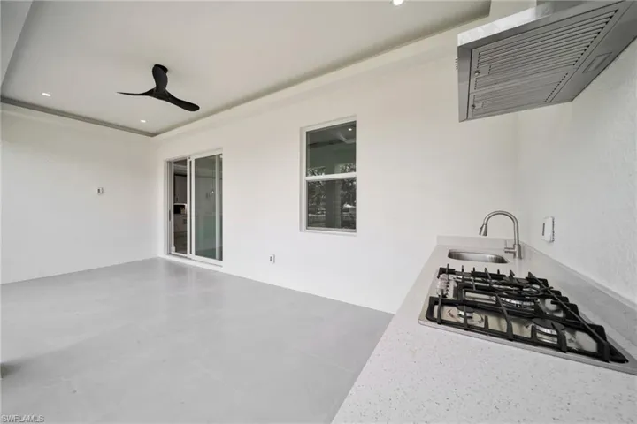 View of patio featuring ceiling fan and a sink