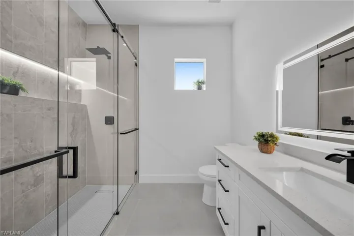 Bathroom featuring vanity and a stall shower