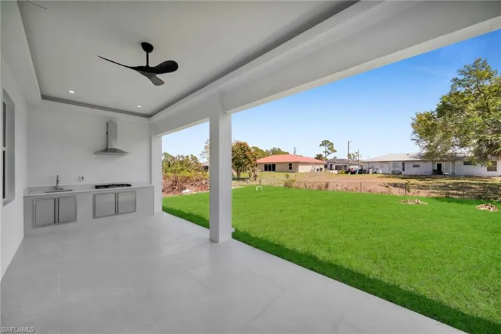 View of patio / terrace featuring an outdoor kitchen and a ceiling fan