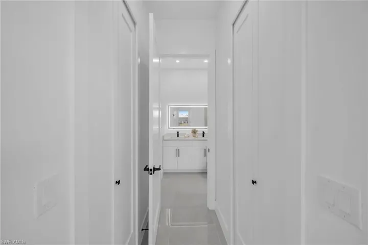 Corridor featuring light tile patterned flooring