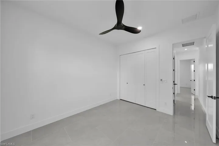 Unfurnished bedroom with a closet, a ceiling fan, and recessed lighting