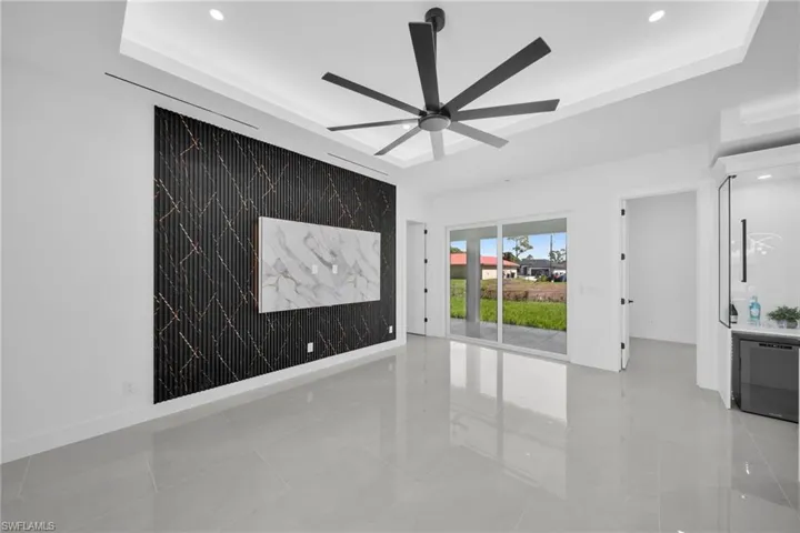 Unfurnished room featuring recessed lighting, a raised ceiling, and ceiling fan