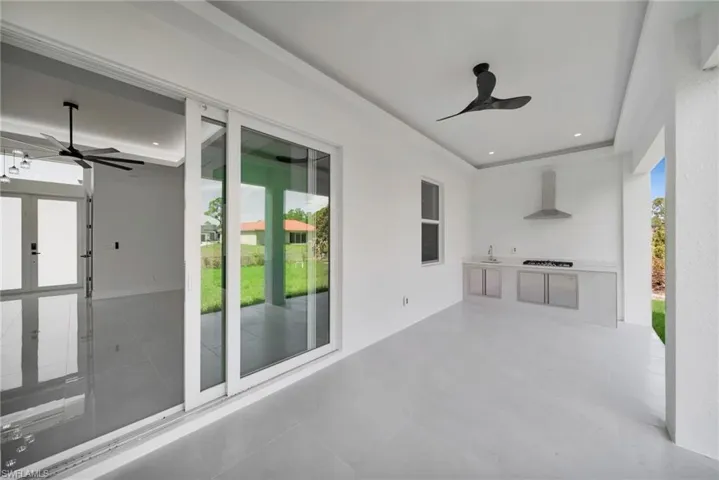 View of patio featuring ceiling fan and area for grilling