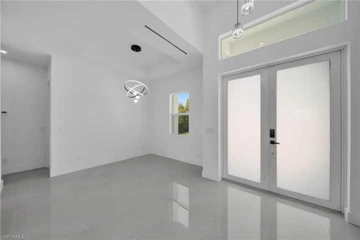 Entryway featuring french doors and hanging lights