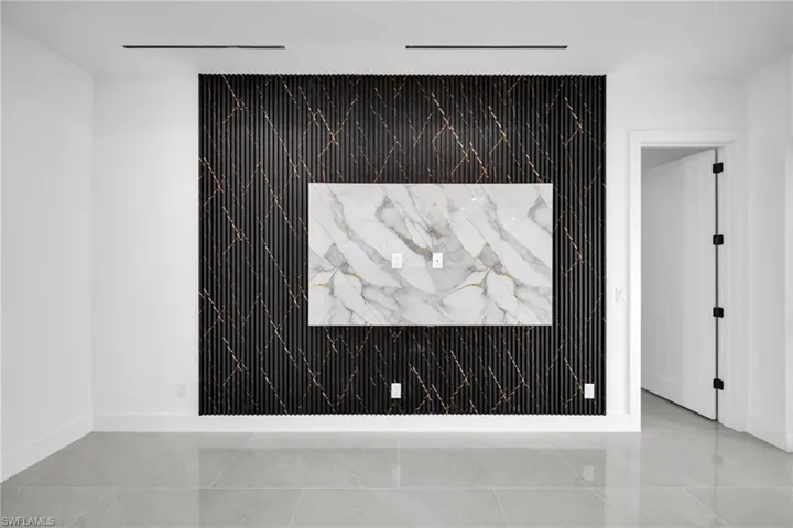 Detailed view of baseboards and an accent wall