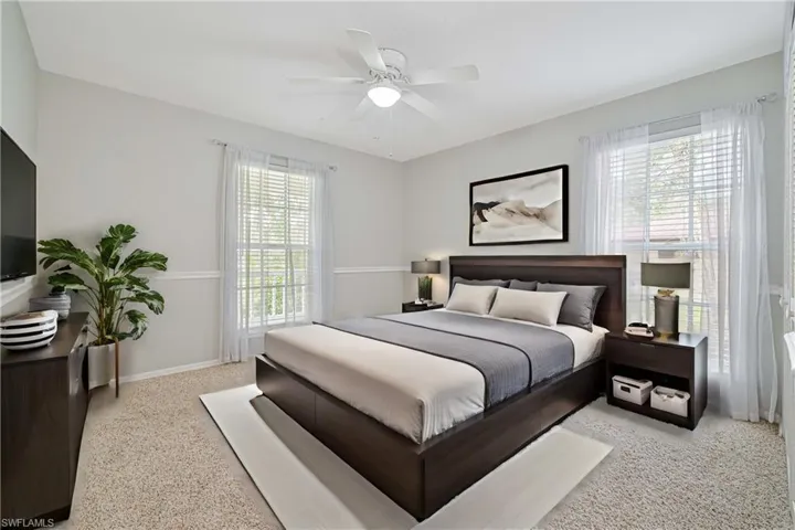 Bedroom featuring light colored carpet and ceiling fan