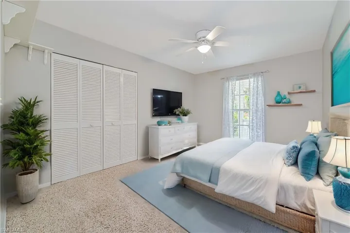 Bedroom featuring ceiling fan and a closet
