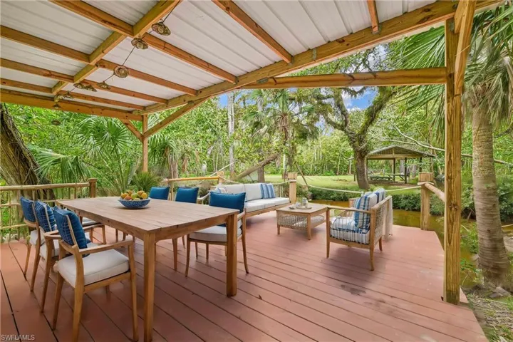Wooden deck with a gazebo and an outdoor hangout area