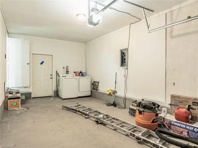 Spacious garage with concrete flooring and overhead garage door opener