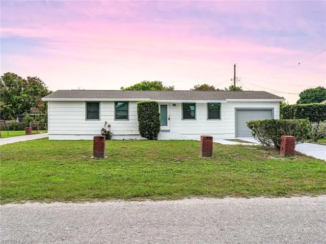 White siding exterior with a dark gray shingle roof