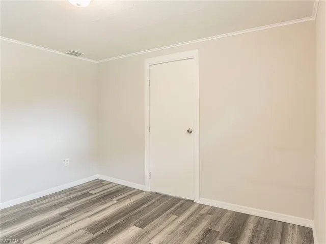 Neutral-toned walls complement the wood-finish flooring
