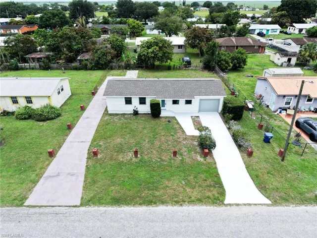 Single-story residence featuring a white exterior and a gray roof