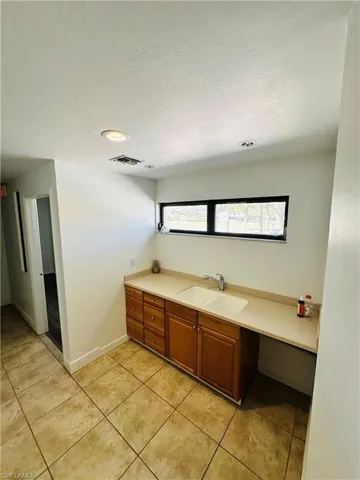 Bathroom featuring tile patterned flooring and sink