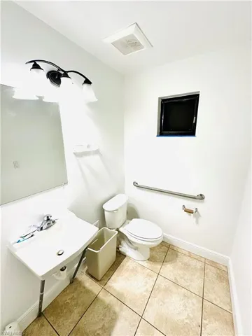 Bathroom with tile patterned flooring and toilet