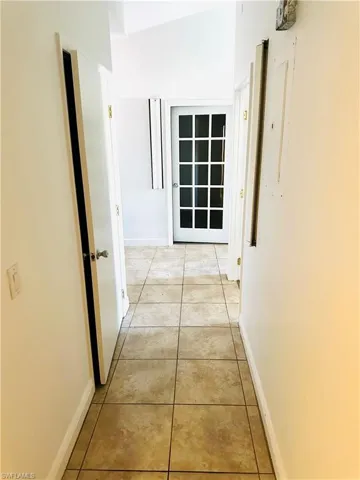 Hallway featuring light tile patterned floors