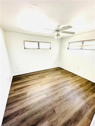 Unfurnished room featuring hardwood / wood-style flooring and ceiling fan