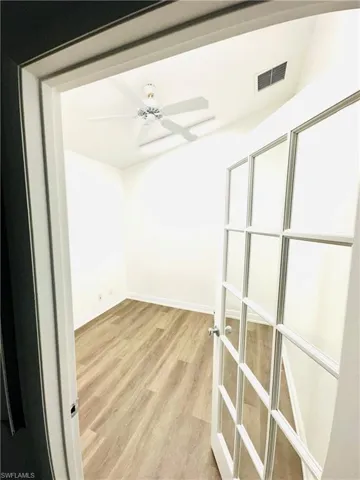 Empty room featuring light hardwood / wood-style flooring, french doors, and ceiling fan