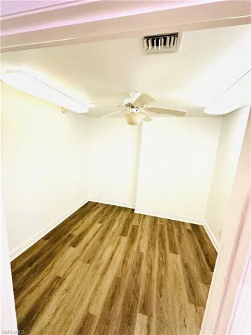Empty room featuring hardwood / wood-style floors and ceiling fan