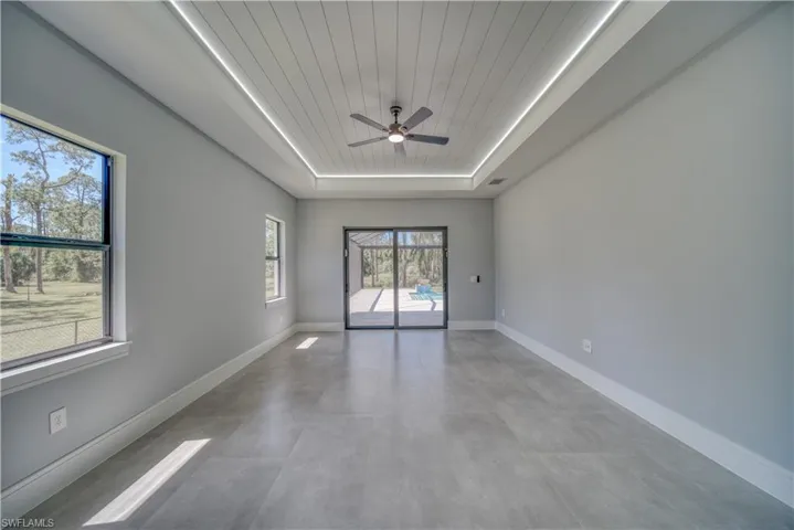 Master Bedroom featuring a tray ceiling, a ceiling fan, and wooden ceiling