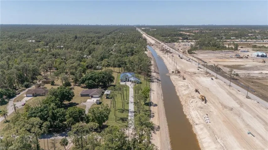 Birds eye view of property featuring Vanderbilt Beach at a distance