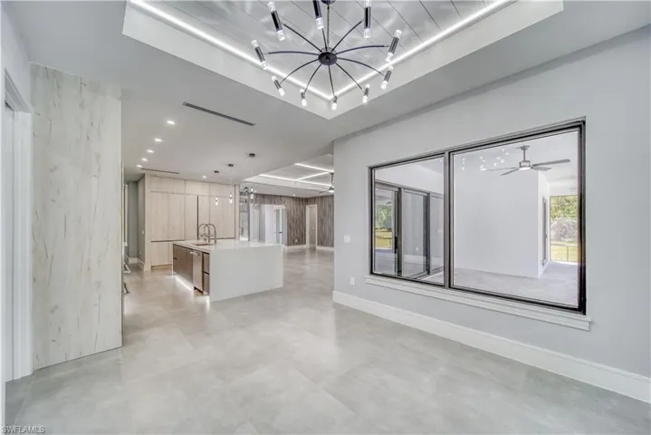 Diving room area with  recessed lighting, rail lighting, a notable chandelier