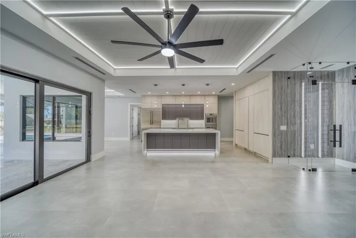 Great room featuring visible vents, recessed lighting, a ceiling fan, kitchen island