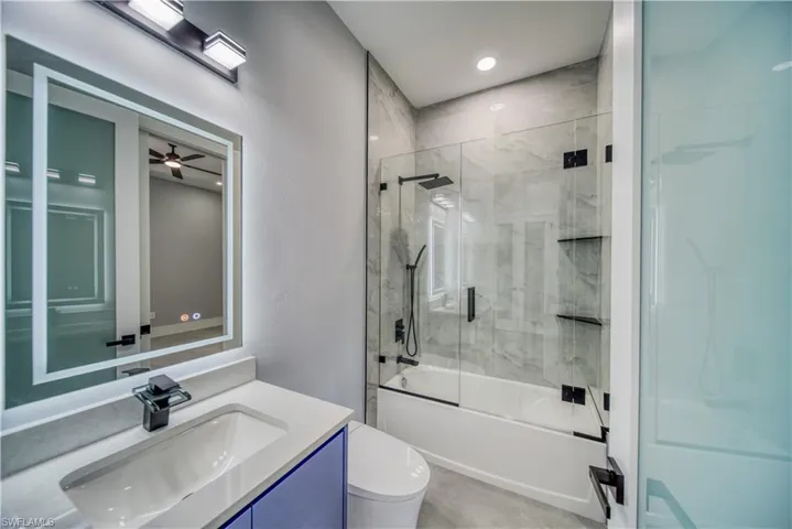 Bathroom #2 with vanity, smart toilet, and enclosed tub / shower combo