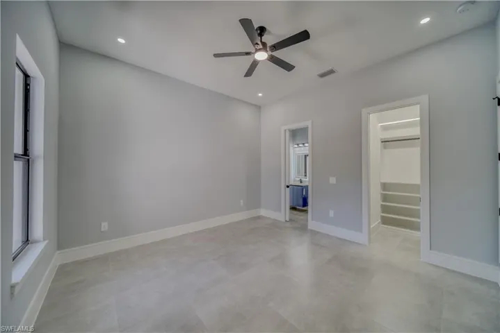 Bedroom #2 featuring a walk in closet, recessed lighting