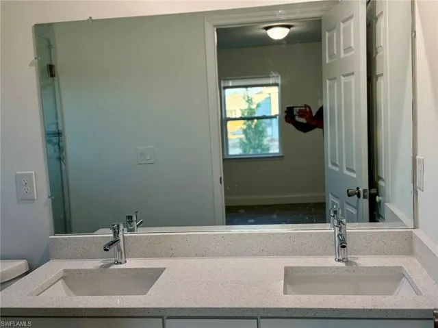 Bathroom featuring vanity and toilet