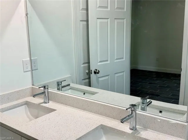 Bathroom with hardwood / wood-style flooring and vanity
