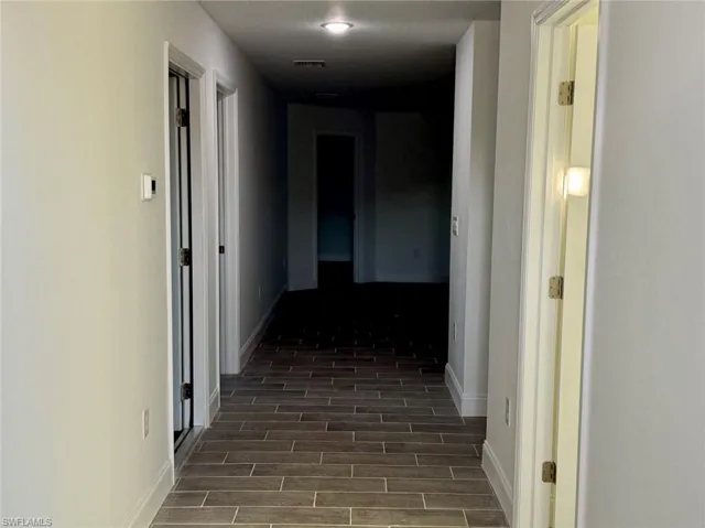 Hallway featuring dark hardwood / wood-style floors