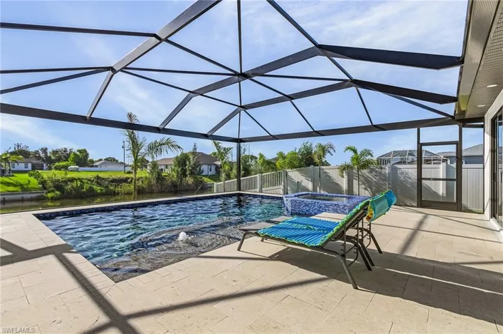 View of pool with a patio area and a lanai